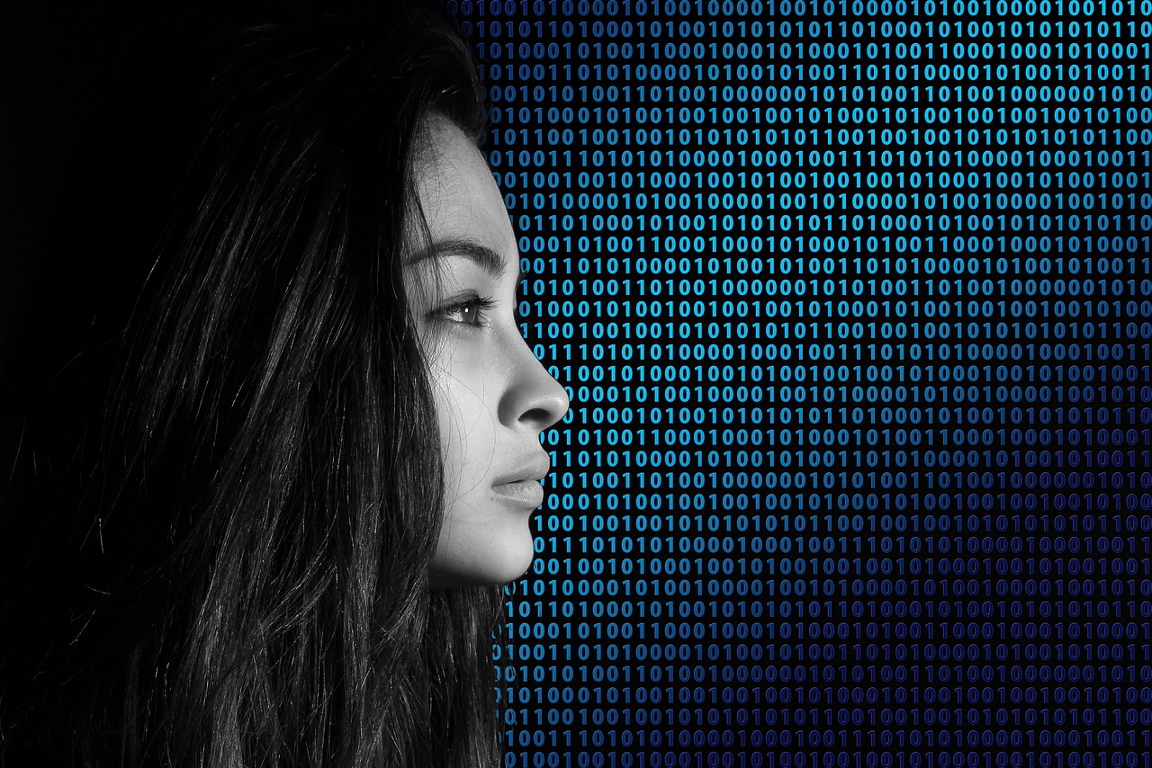 the profile of a woman on top of binary code